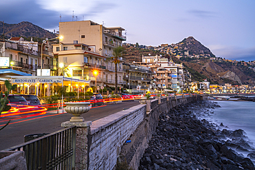 View of Taormina and Giardini Naxos promenade viewed from Giardini Naxos at dusk, Sicily, Mediterranean, Italy, Mediterranean, Europe