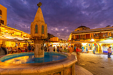 View of fountain in Hippocrates Square at dusk, Old Rhodes Town, UNESCO World Heritage Site, Rhodes, Dodecanese, Greek Islands, Greece, Europe