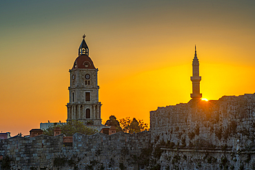 View of sunrise between Medieval Clock Tower and Mosque of Suleiman, Rhodes Town, Rhodes, Dodecanese Island Group, Greek Islands, Greece, Europe