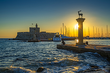 View of bronze stag and doe statues and Saint Nicholas Fortress at sunrise, City of Rhodes, Rhodes, Dodecanese Islands, Greek Islands, Greece, Europe