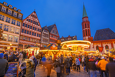 View of carousel and Christmas Market on Roemerberg Square at dusk, Frankfurt am Main, Hesse, Germany, Europe