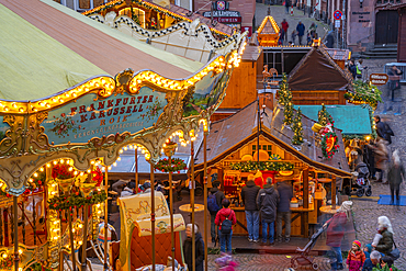 View of carousel and stalls of Christmas Market, at dusk, Roemerberg Square, Frankfurt am Main, Hesse, Germany, Europe