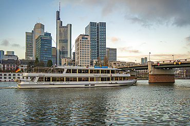 View of city skyline, river cruise boat and River Main at sunset, Frankfurt am Main, Hesse, Germany, Europe