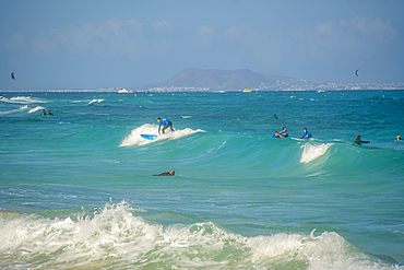 View of surfboarders and the Atlantic Ocean, Corralejo Natural Park, Fuerteventura, Canary Islands, Spain, Atlantic, Europe