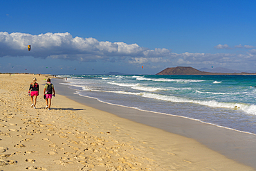 View of couple walking on beach and the Atlantic Ocean, Corralejo Natural Park, Fuerteventura, Canary Islands, Spain, Atlantic, Europe