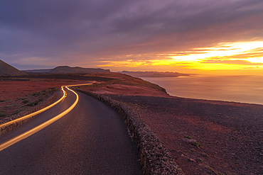 View of trail lights and volcanic coastline from Mirador del Rio at sunset, Lanzarote, Las Palmas, Canary Islands, Spain, Atlantic, Europe