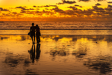 View of couple at sunset on Kuta Beach, Kuta, Bali, Indonesia, South East Asia, Asia