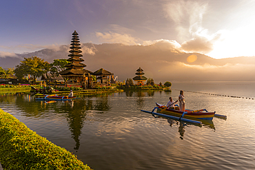 View of young couple on Cadik canoe at Ulun Danu Beratan temple on Lake Bratan at sunrise, Bali, Indonesia, South East Asia, Asia