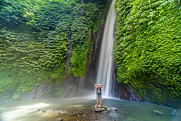 View of woman taking picture at Melanting waterfall, Kabupaten Buleleng, Gobleg, Bali, Indonesia, South East Asia, Asia