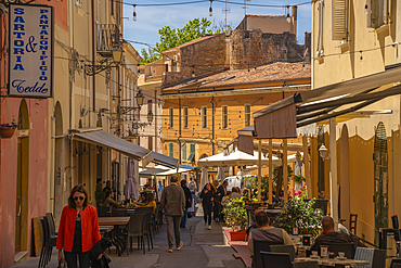 View of narrow street lined with cafes and rustic buildings in Sassari, Sassari, Sardinia, Italy, Mediterranean, Europe