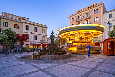 View of carousel and fountain on Piazza Matteotti at dusk, Olbia, Sardinia, Italy, Mediterranean, Europe