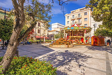 View of carousel and fountain on Piazza Matteotti on sunny day in Olbia, Olbia, Sardinia, Italy, Mediterranean, Europe