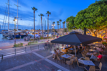 View of cafes and boats in Kos Harbour at dusk, Kos Town, Kos, Dodecanese, Greek Islands, Greece, Europe