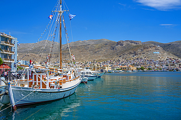 View of port and town of Kalimnos with hills in the background, Kalimnos, Dodecanese Islands, Greek Islands, Greece, Europe