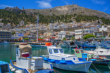 View of harbour boats in Kalimnos with hills in the background, Kalimnos, Dodecanese Islands, Greek Islands, Greece, Europe