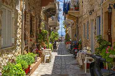 View of narrow street leading towards harbour in Kalimnos, Kalimnos, Dodecanese Islands, Greek Islands, Greece, Europe