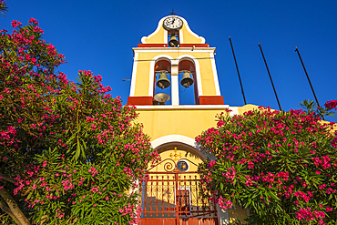 View of church bell tower overlooking Fiscardo harbour, Fiscardo, Kefalonia, Ionian Islands, Greek Islands, Greece, Europe