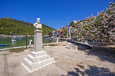 View of statue and colourful houses in Assos, Assos, Kefalonia, Ionian Islands, Greek Islands, Greece, Europe