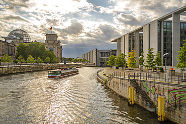 View of sightseeing cruise boat on River Spree and the Reichstag (German Parliament building), Mitte, Berlin, Germany, Europe