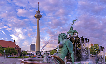 View of Berliner Fernsehturm and Neptunbrunnen fountain at dusk, Panoramastrasse, Berlin, Germany, Europe