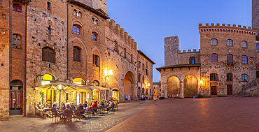 View of restaurants in Piazza del Duomo at dusk, San Gimignano, UNESCO World Heritage Site, Province of Siena, Tuscany, Italy, Europe