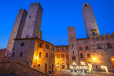 View of restaurants in Piazza del Duomo at dusk, San Gimignano, UNESCO World Heritage Site, Province of Siena, Tuscany, Italy, Europe