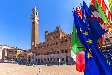 View of flags and Palazzo Pubblico in Piazza del Campo, UNESCO World Heritage Site, Siena, Tuscany, Italy, Europe