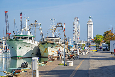 View of boats on Rimini canal and lighthouse, Rimini, Emilia-Romagna, Italy, Europe