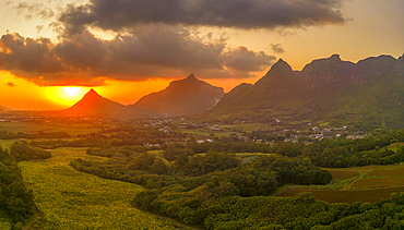 View of golden sunset behind Long Mountain and patchwork of green fields, Mauritius, Indian Ocean, Africa