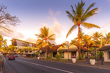 View of palm trees and boutique shops in Grand Bay at sunset, Mauritius, Indian Ocean, Africa