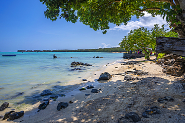 View of man fishing from Mont Choisy Beach and turquoise Indian Ocean on sunny day, Mauritius, Indian Ocean, Africa