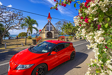 View of red car and Notre-Dame Auxiliatrice de Cap Malheureux, Cap Malheureux, Mauritius, Indian Ocean, Africa