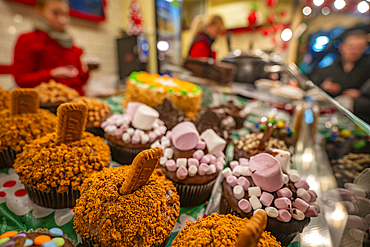 Cakes on Christmas Market stall in Old Market Square at dusk, Nottingham, Nottinghamshire, England, United Kingdom, Europe