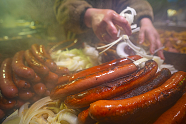 Frankfurter sausages on Christmas Market stall in Old Market Square at dusk, Nottingham, Nottinghamshire, England, United Kingdom, Europe