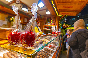 View of toffee apples on Christmas Market stall in Victoria Square at dusk, Birmingham, West Midlands, England, United Kingdom, Europe