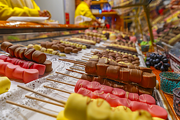 View of chocolates on Christmas Market stall in Victoria Square at dusk, Birmingham, West Midlands, England, United Kingdom, Europe