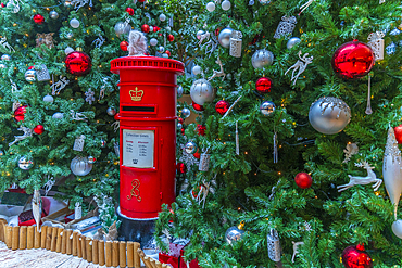 View of red postbox and Christmas decoration in hotel lobby, London, England, United Kingdom, Europe