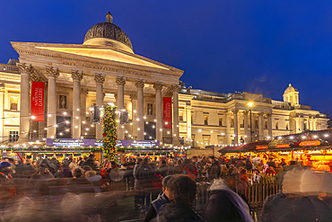 View of Christmas market and The National Gallery in Trafalgar Square at dusk, Westminster, London, England, United Kingdom, Europe