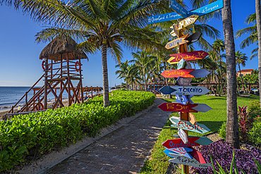 View of colourful hotel destination signpost near Puerto Morelos, Caribbean Coast, Yucatan Peninsula, Mexico, North America