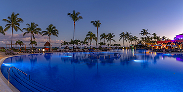 View of hotel pool and sea at dusk near Puerto Morelos, Quintana Roo, Caribbean Coast, Yucatan Peninsula, Riviera Maya, Mexico, North America