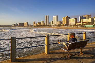 View of promenade, beach and hotels from pier in Indian Ocean at sunrise, Durban, KwaZulu-Natal Province, South Africa, Africa