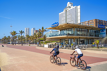 View of cyclists, cafe and hotels on promenade, Durban, KwaZulu-Natal Province, South Africa, Africa