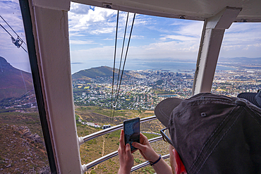 View of man taking picture of Cape Town from Table Mountain Aerial Cableway, Cape Town, Western Cape, South Africa, Africa