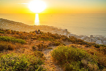 Couple watching sunset over Bantry Bay from Signal Hill, Cape Town, Western Cape, South Africa, Africa