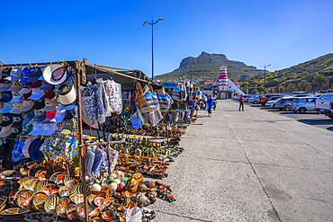 View of souvenir stalls and colourful bar and lighthouse in Hout Bay Harbour, Hout Bay, Cape Town, Western Cape, South Africa, Africa