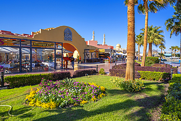 View of cafe and restaurant in Hurghada Marina and Al Mina Mosque in background, Hurghada, Red Sea Governorate, Egypt, North Africa, Africa