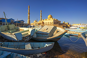 View of colourful wooden boats in Hurghada Harbour and Al Mina Mosque in background, Hurghada, Red Sea Governorate, Egypt, North Africa, Africa