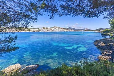 View of rocky shoreline by turquoise sea and Santa Ponsa, Majorca, Balearic Islands, Spain, Mediterranean, Europe