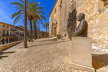 View of palm trees ad statue beside Sant Bartomeu church, Montuiri, Majorca, Balearic Islands, Spain, Mediterranean, Europe