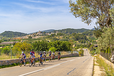 View of cyclists and hilltop town of Selva, Majorca, Balearic Islands, Spain, Mediterranean, Europe